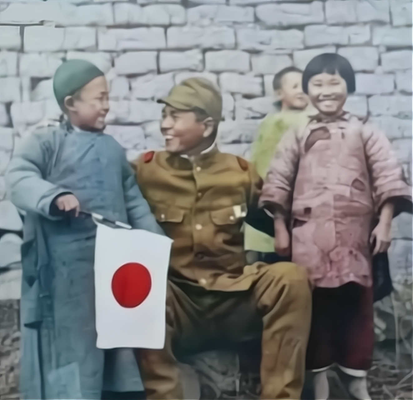 这张老照片拍摄于1938年,展现了一个日本军官坐在石头上,搂着两个小